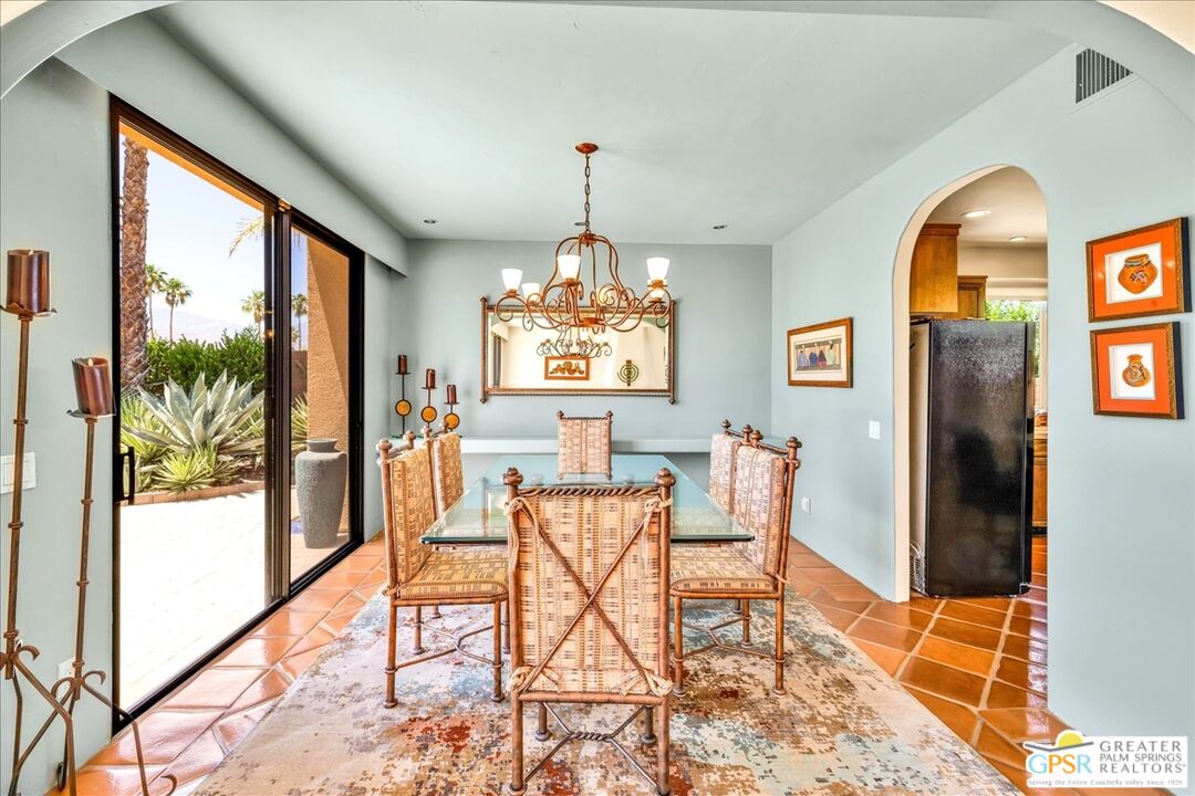 71121 Sunny Lane Rancho Mirage, CA 92270 - Photo 26 of 75 a dining room with furniture a chandelier and wooden floor
