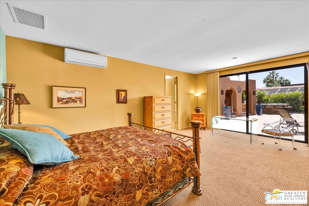 71121 Sunny Lane Rancho Mirage, CA 92270 - Photo 31 of 75 a spacious bedroom with a bed and glass windows