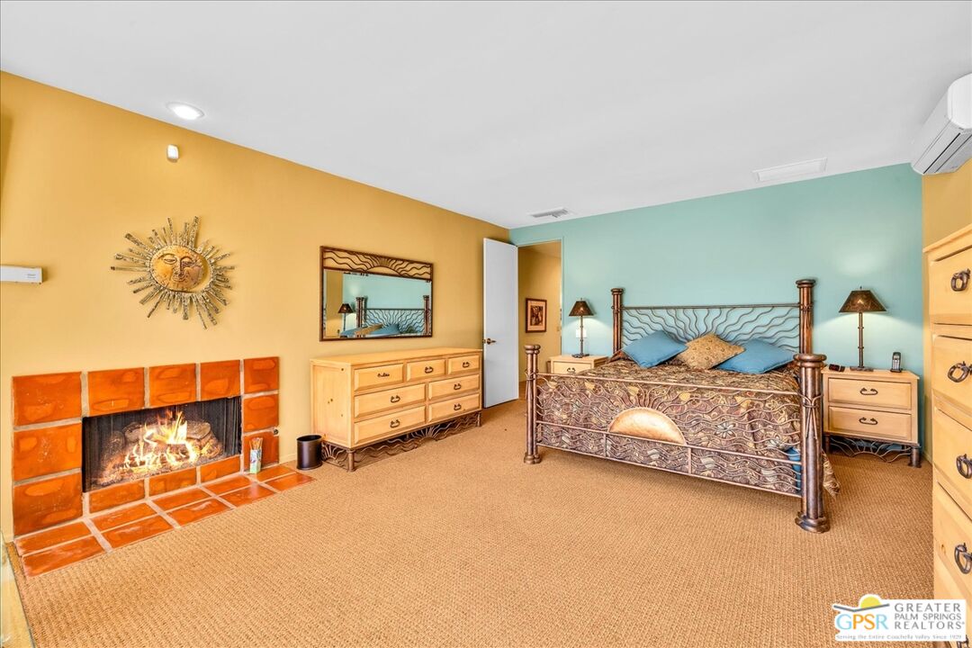 71121 Sunny Lane Rancho Mirage, CA 92270 - Photo 33 of 75 a bedroom with a bed and lamp with paintings on the wall