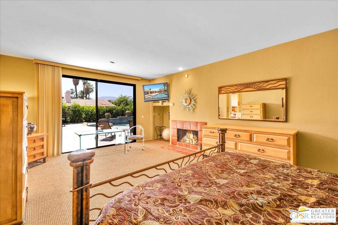 71121 Sunny Lane Rancho Mirage, CA 92270 - Photo 34 of 75 a living room with furniture large window and flat screen tv