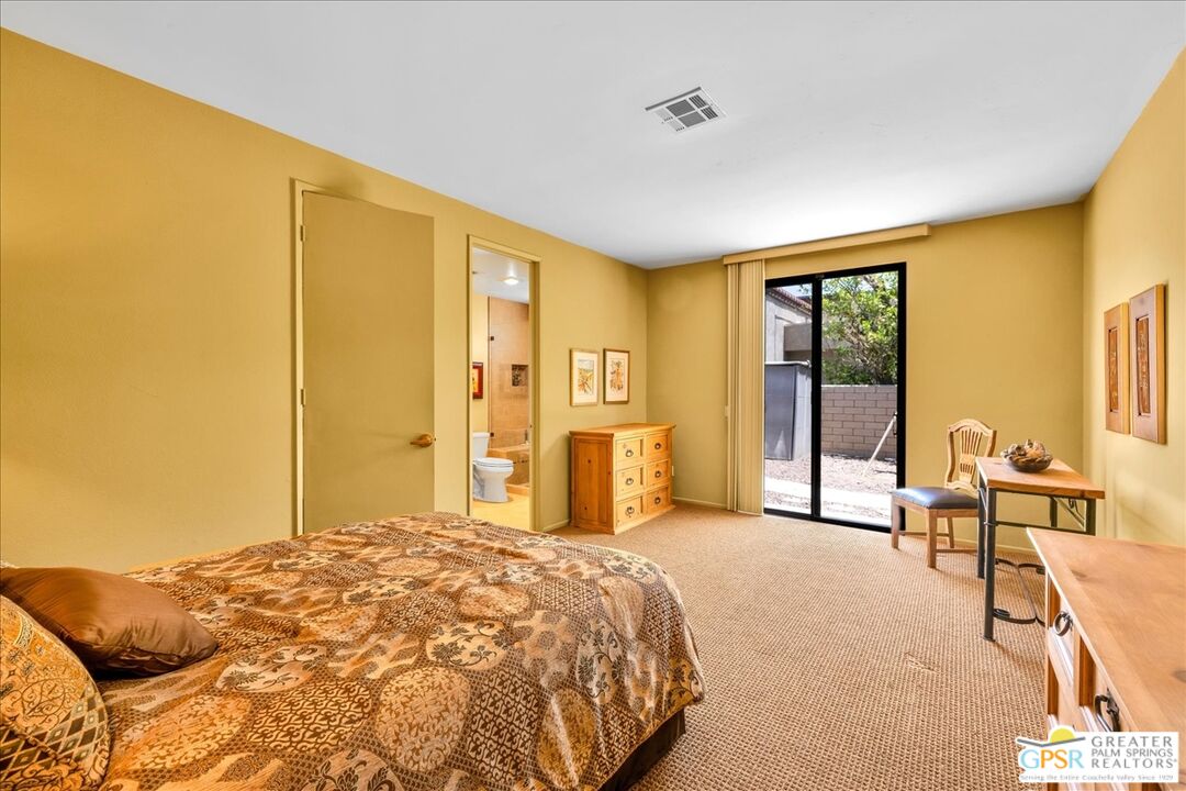 71121 Sunny Lane Rancho Mirage, CA 92270 - Photo 37 of 75 a bedroom with a bed and large windows