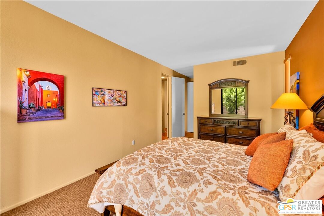 71121 Sunny Lane Rancho Mirage, CA 92270 - Photo 42 of 75 a bedroom with a large bed and a chandelier