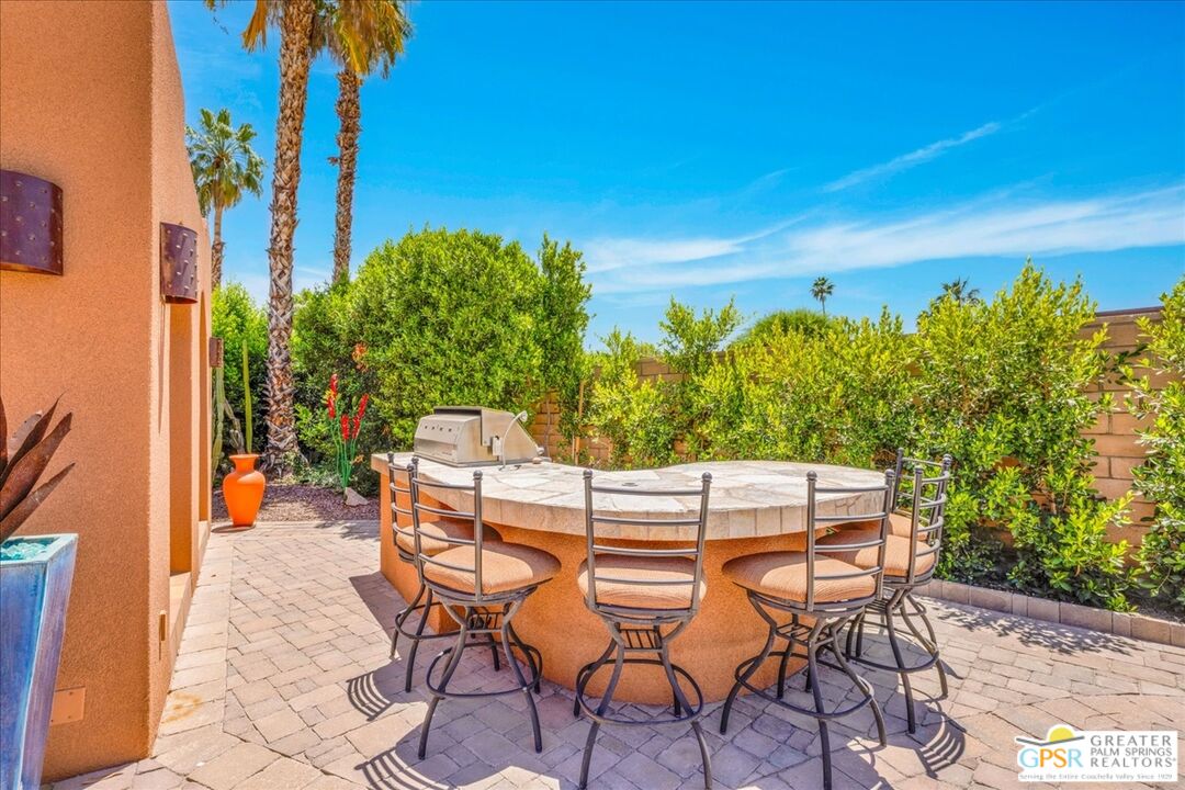 71121 Sunny Lane Rancho Mirage, CA 92270 - Photo 50 of 75 a view of patio with table and chairs and potted plants