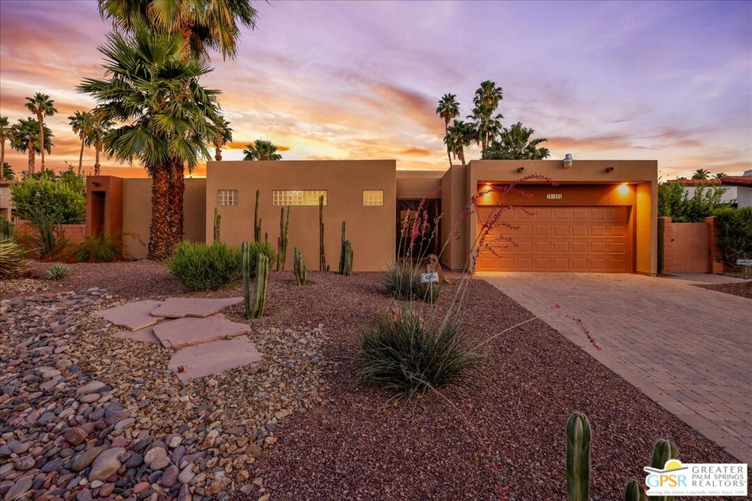 71121 Sunny Lane Rancho Mirage, CA 92270 - Photo 63 of 75 a front view of a house with a yard and potted plants