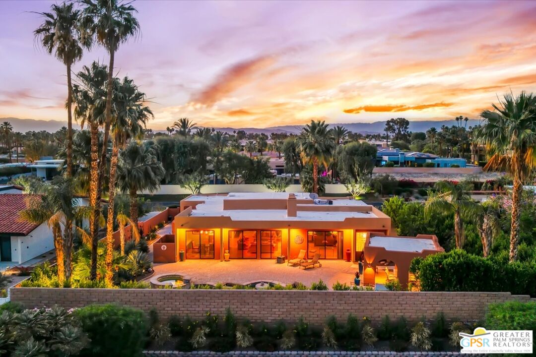 71121 Sunny Lane Rancho Mirage, CA 92270 - Photo 64 of 75 a view of a swimming pool with an outdoor seating and a garden