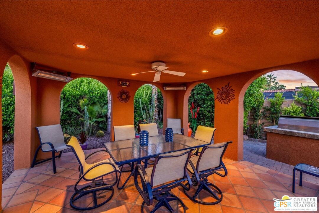 71121 Sunny Lane Rancho Mirage, CA 92270 - Photo 70 of 75 a view of a patio with table and chairs with wooden floor and fence