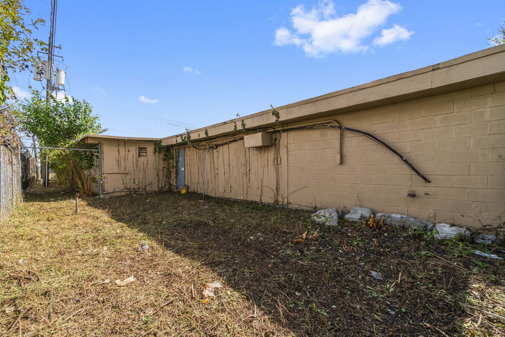 1018 Shaver Street Pasadena, TX 77506 - Photo 20 of 43 Secure rear exterior with gated access and utility connections