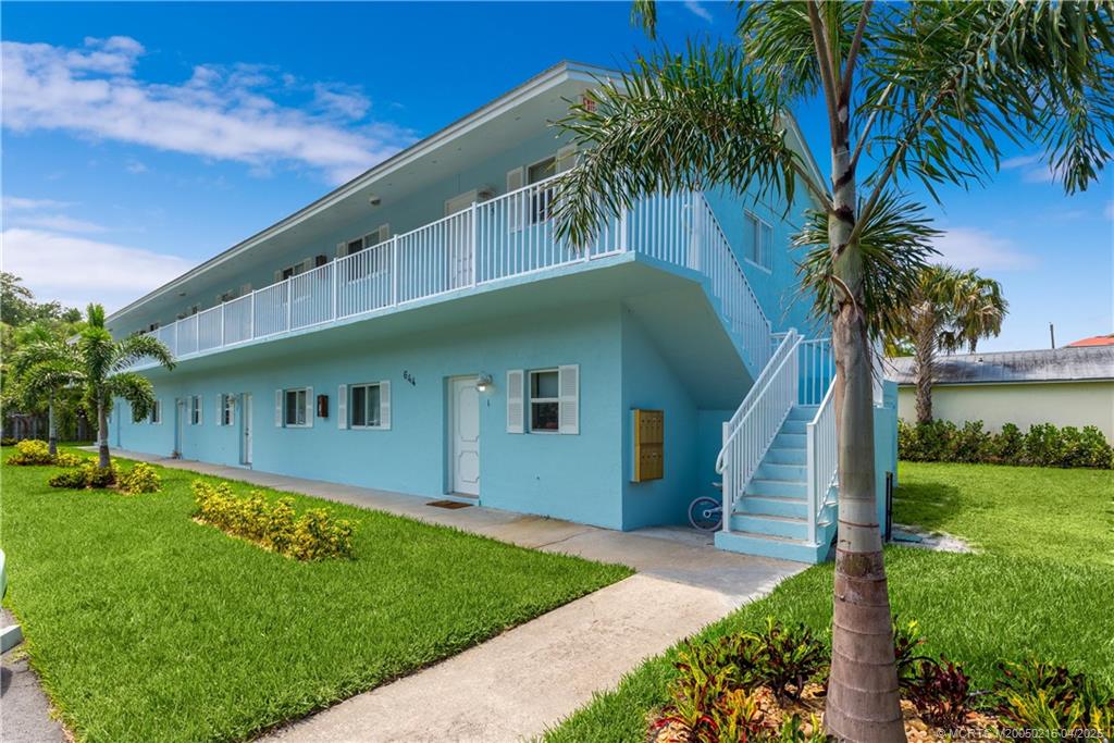 644 Southwest Cleveland Avenue, Unit 6 Stuart, FL 34994 - Photo 20 of 22 a front view of house with yard and green space
