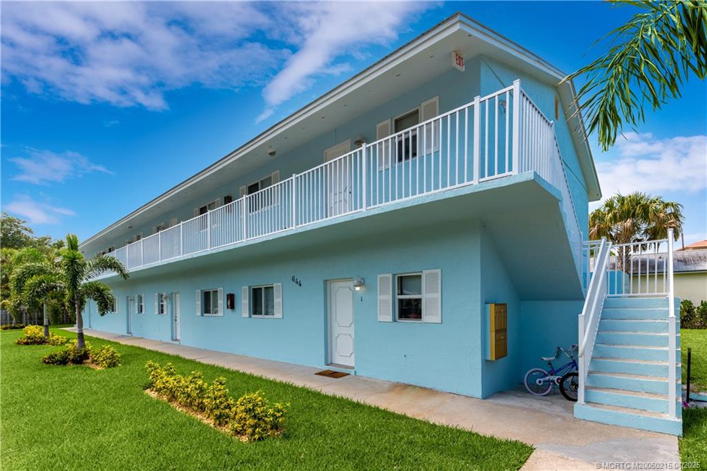 644 Southwest Cleveland Avenue, Unit 6 Stuart, FL 34994 - Photo 21 of 22 a front view of house with yard and entertaining space