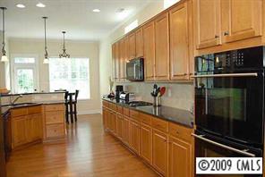 926 Treasure Court Fort Mill, SC 29708 - Photo 2 of 8 a kitchen with stainless steel appliances granite countertop a stove a sink and a microwave