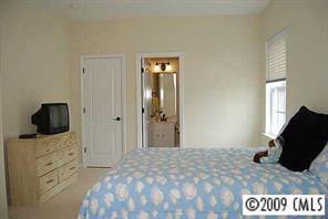 926 Treasure Court Fort Mill, SC 29708 - Photo 8 of 8 a bedroom with a bed and flat screen tv