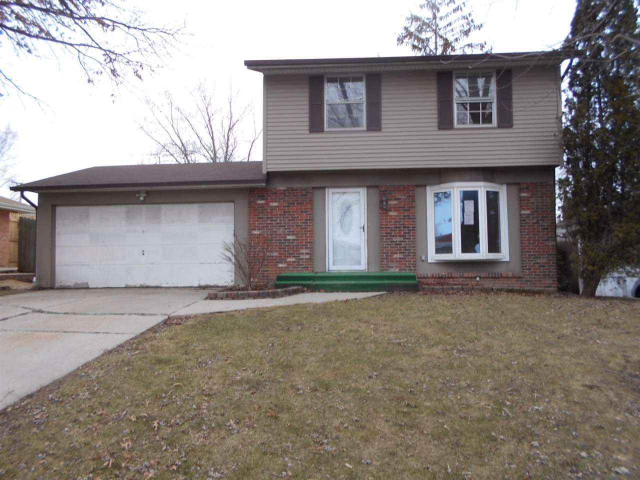 1017 Kenmore Road Rockford, IL 61108 - Photo 1 of 9 a front view of a house with a yard and garage