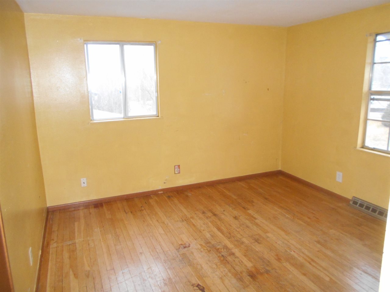 1017 Kenmore Road Rockford, IL 61108 - Photo 7 of 9 a view of an empty room with wooden floor and a window