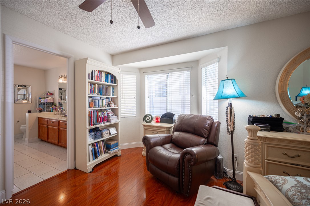718 Rusty Spur Drive Henderson, NV 89014 - Photo 47 of 50 Hardwood flooring extends throughout this cozy bedroom with a reading nook and bay windows.
