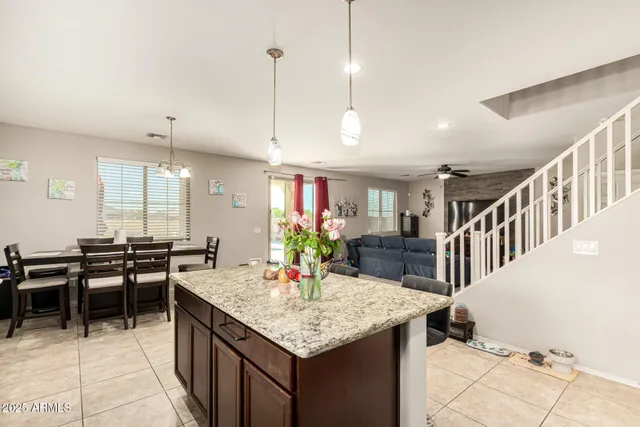 a kitchen with center island table and chairs