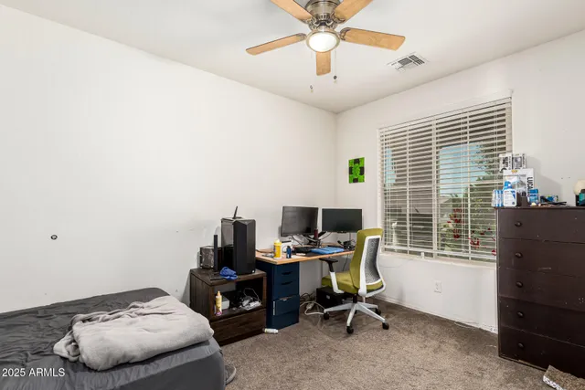 a view of a workspace with furniture and a window