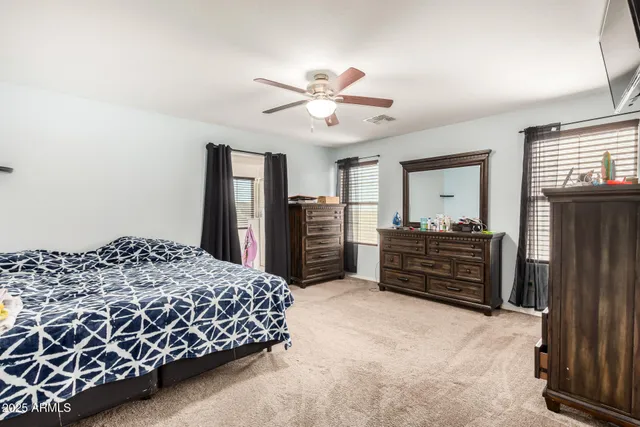 a bedroom with a bed dresser and a window