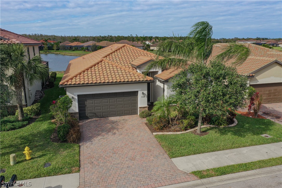 8944 Water Tupelo Road Fort Myers, FL 33912 - Photo 1 of 29 a front view of a house with garden