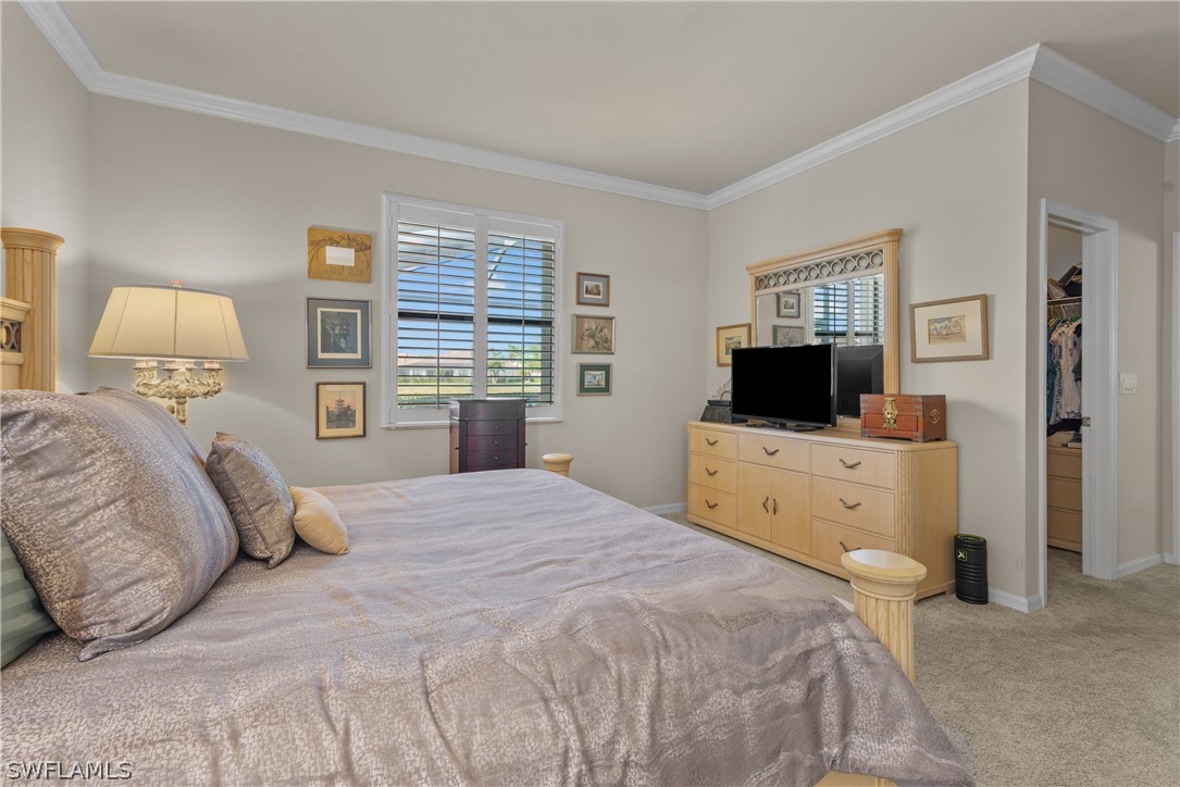 8944 Water Tupelo Road Fort Myers, FL 33912 - Photo 4 of 29 a bedroom with a bed and a flat screen tv