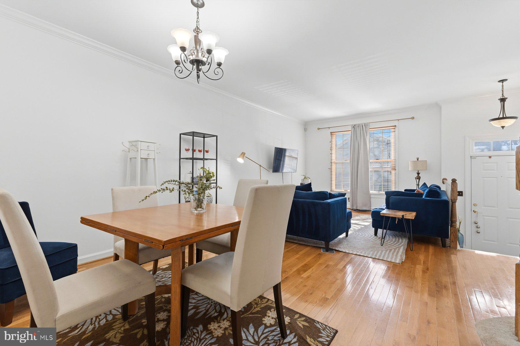 3632 Ransom Place Alexandria, VA 22306 - Photo 5 of 33 a view of a dining room with furniture a chandelier and wooden floor