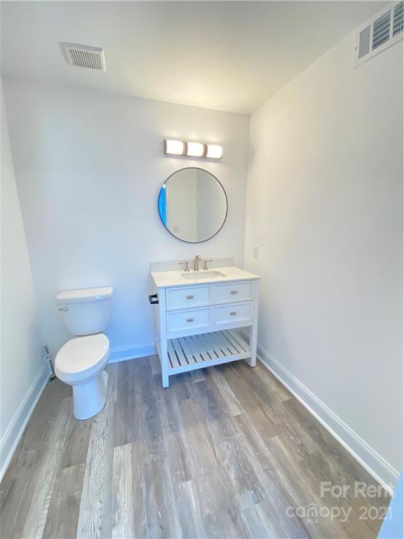 621 Stallings Road, Unit A Matthews, NC 28104 - Photo 10 of 10 a bathroom with a sink mirror and toilet
