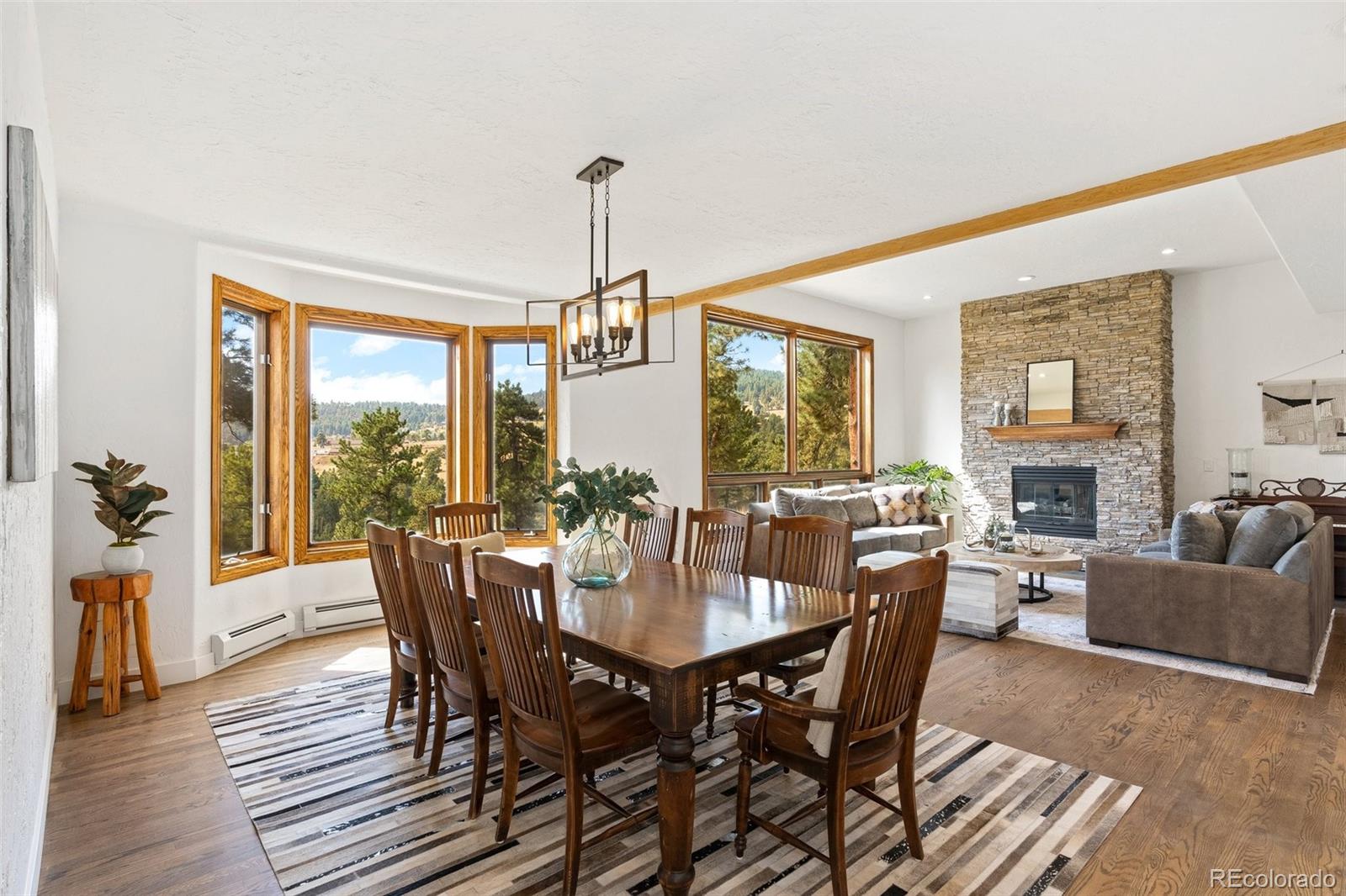 24140 Highway 40 Golden, CO 80401 - Photo 11 of 40 a view of a dining room with furniture window and wooden floor