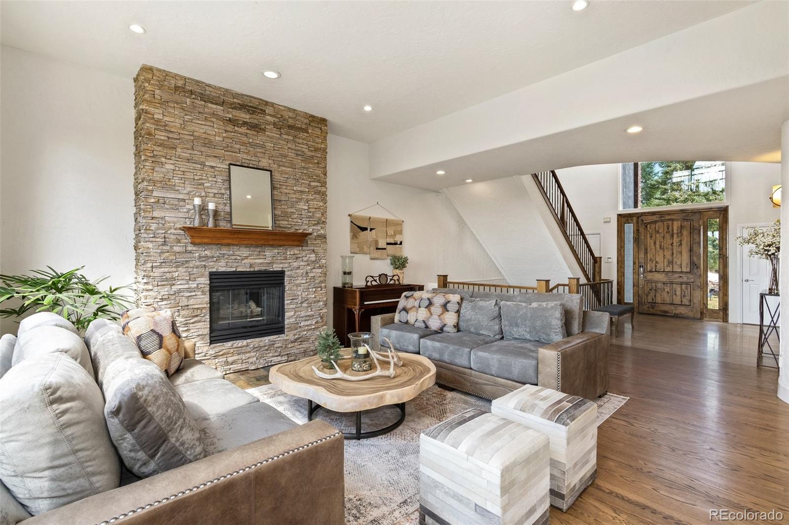 24140 Highway 40 Golden, CO 80401 - Photo 12 of 40 a living room with furniture and a fireplace
