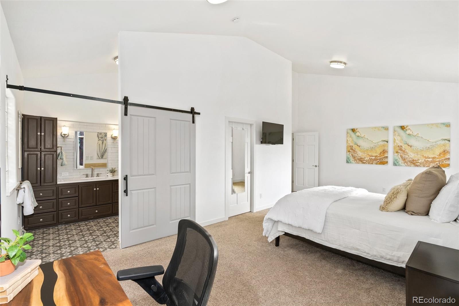 24140 Highway 40 Golden, CO 80401 - Photo 16 of 40 a bedroom with a bed and wooden floor