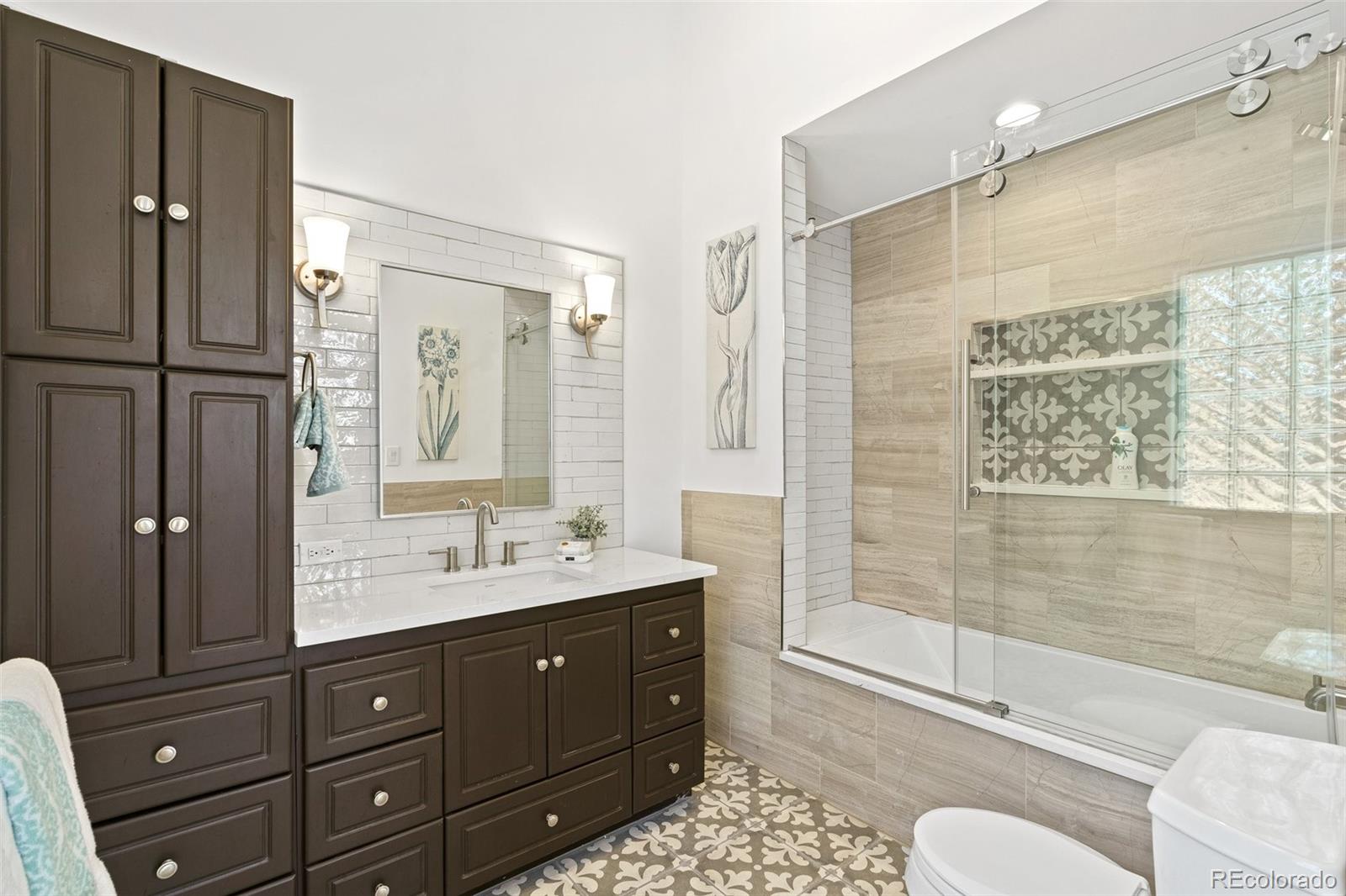 24140 Highway 40 Golden, CO 80401 - Photo 17 of 40 a bathroom with a double vanity sink toilet mirror and shower