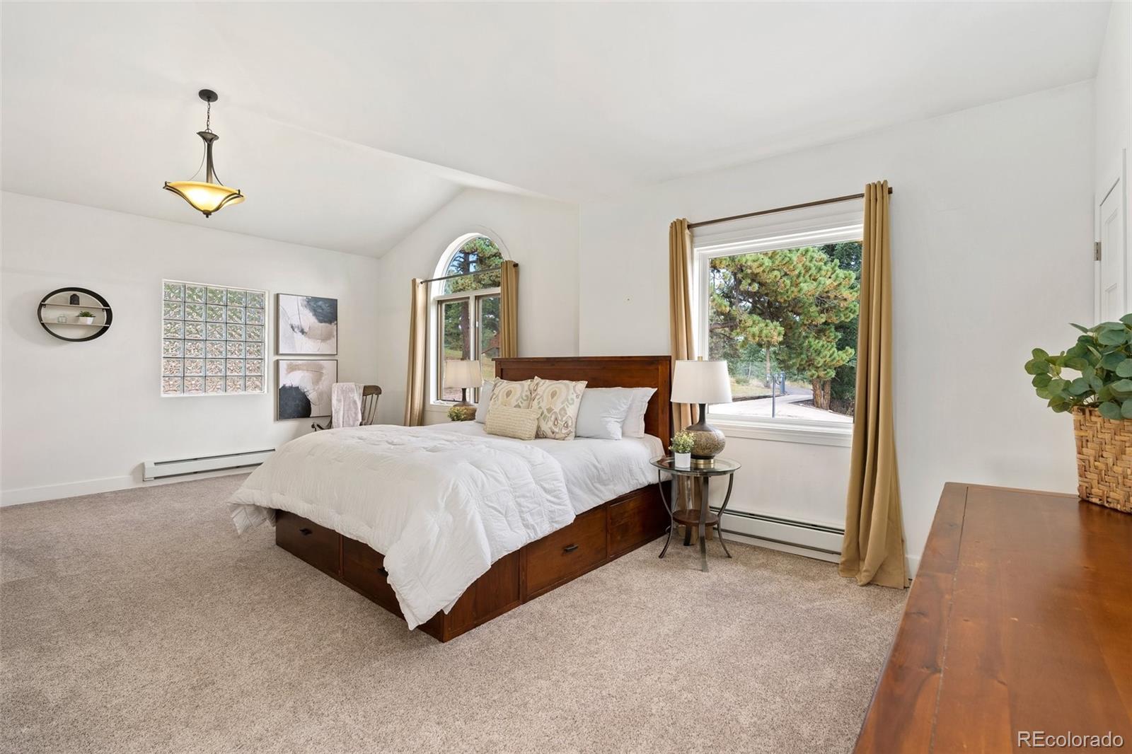 24140 Highway 40 Golden, CO 80401 - Photo 18 of 40 a spacious bedroom with a bed and a window