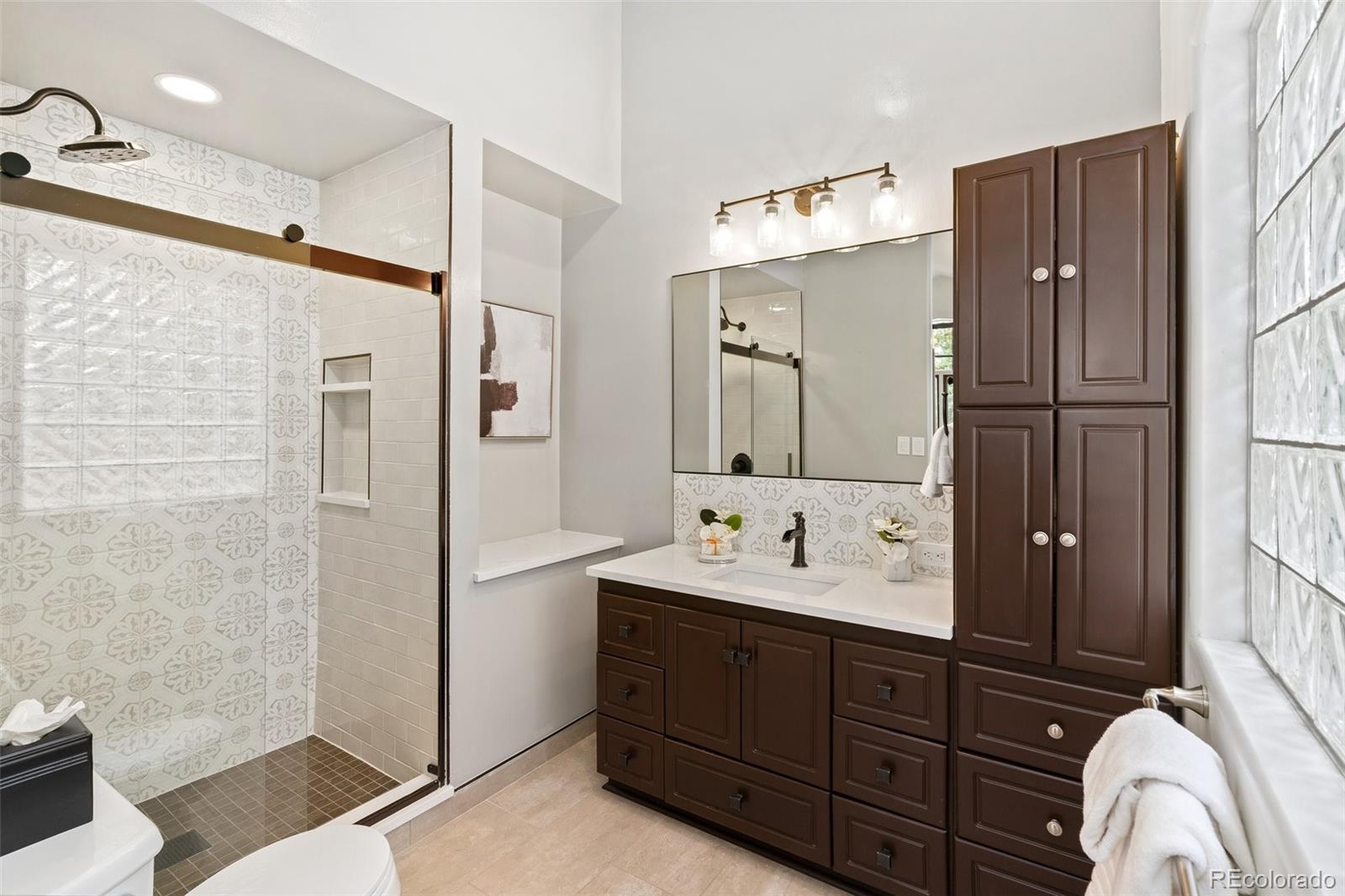 24140 Highway 40 Golden, CO 80401 - Photo 20 of 40 a bathroom with a double vanity sink mirror and shower