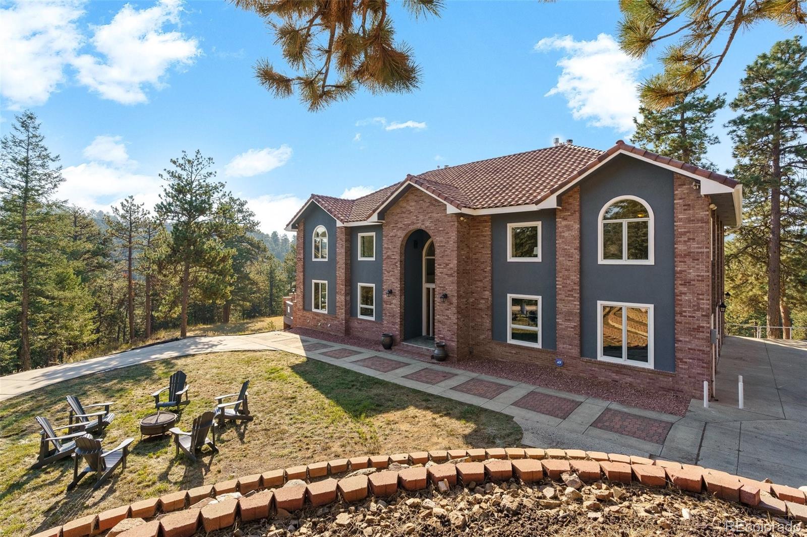 24140 Highway 40 Golden, CO 80401 - Photo 2 of 40 a front view of a house with garden