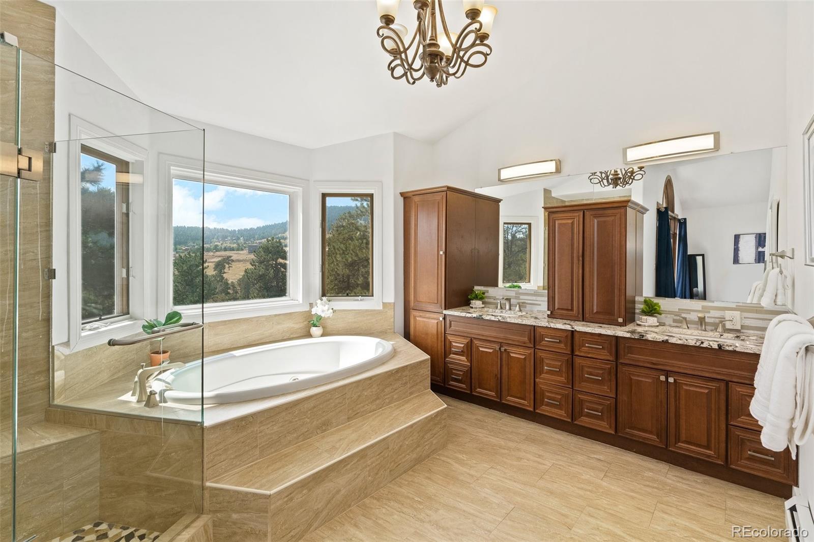 24140 Highway 40 Golden, CO 80401 - Photo 22 of 40 a spacious bathroom with a granite countertop tub sink and mirror
