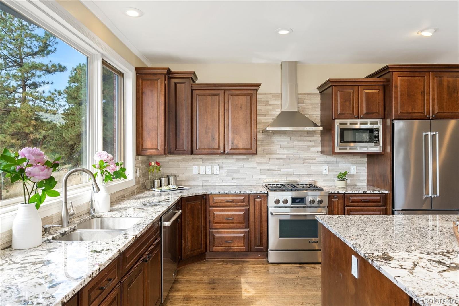 24140 Highway 40 Golden, CO 80401 - Photo 9 of 40 a kitchen with stainless steel appliances granite countertop a sink a stove and a refrigerator