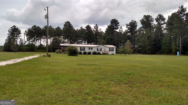 1968 Altamaha School Road Baxley, GA 31513 - Photo 1 of 1 a view of a big yard with a large trees