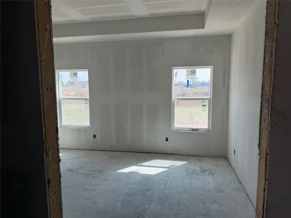 a view of a hallway with a white cabinet and a door