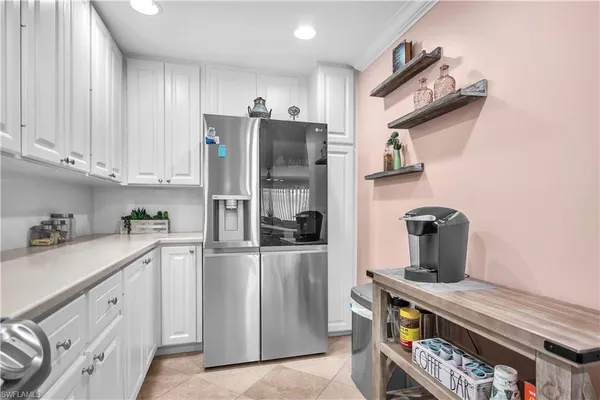 a kitchen with stainless steel appliances granite countertop a refrigerator a stove and a sink
