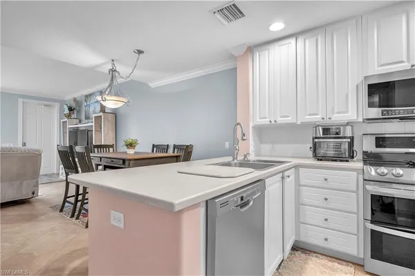a kitchen with a stove a sink and a refrigerator