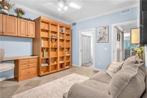 a bed room with a bed and a chair