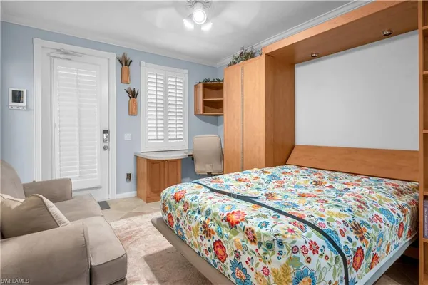 a bedroom with a bed and a television