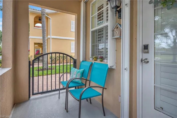 a view of a balcony with furniture
