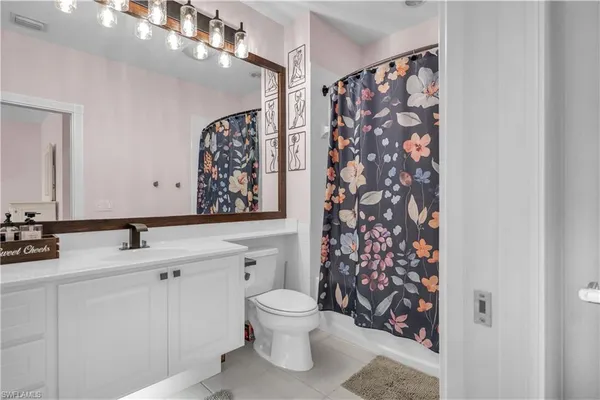 a bathroom with a double vanity sink mirror and toilet
