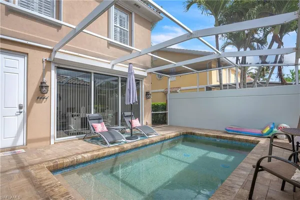 a view of a swimming pool with a lounge chair