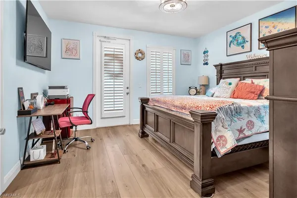 a bedroom with a bed and a chair in it