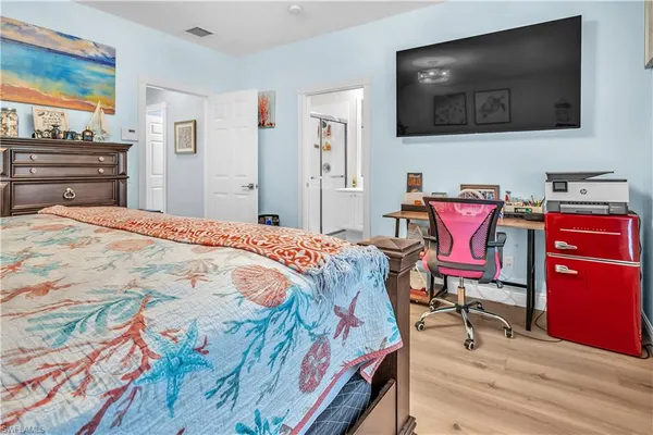 a bedroom with a bed and flat screen tv
