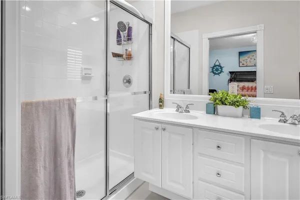 a bathroom with a double vanity sink and mirror