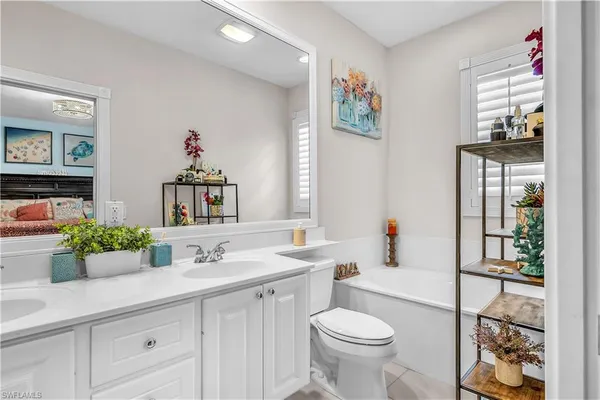 a bathroom with a sink a mirror and a toilet