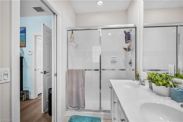 a bathroom with a granite countertop shower sink and vanity