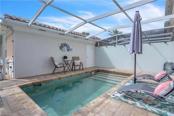 a view of a backyard with a tub and wooden floors