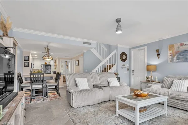 a living room with furniture and a chandelier